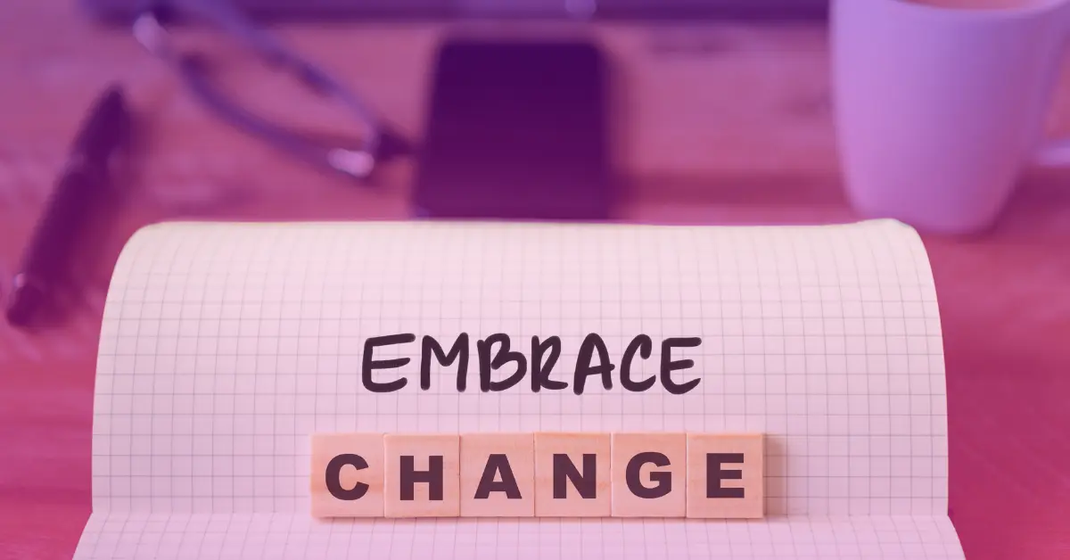 Notebook displaying 'Embrace Change' message.