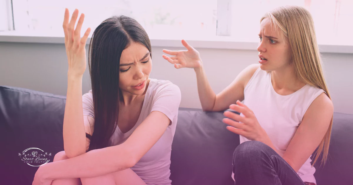 Two women having a disagreement on a couch.