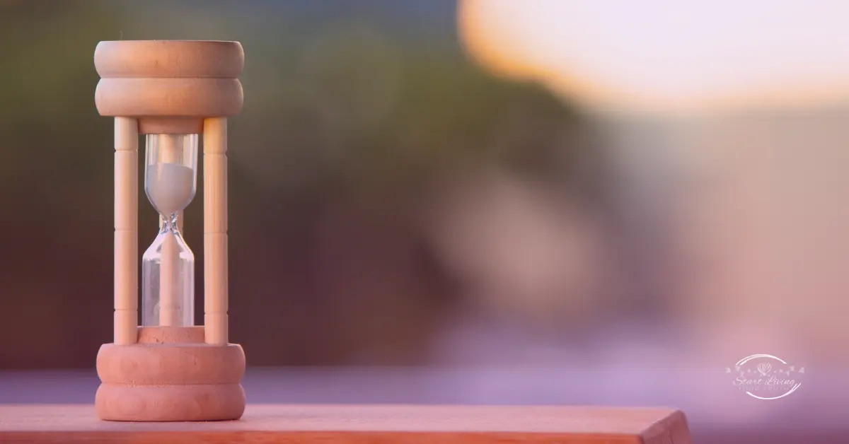 Wooden hourglass on blurred background