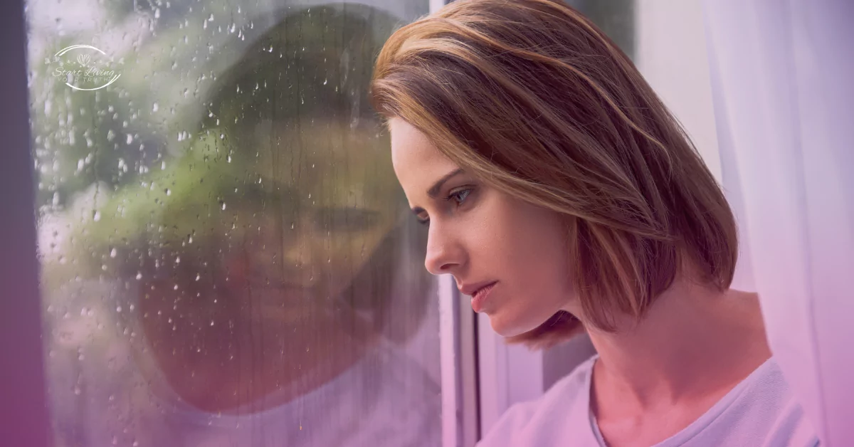 Woman gazing outside rain-streaked window, contemplative mood.