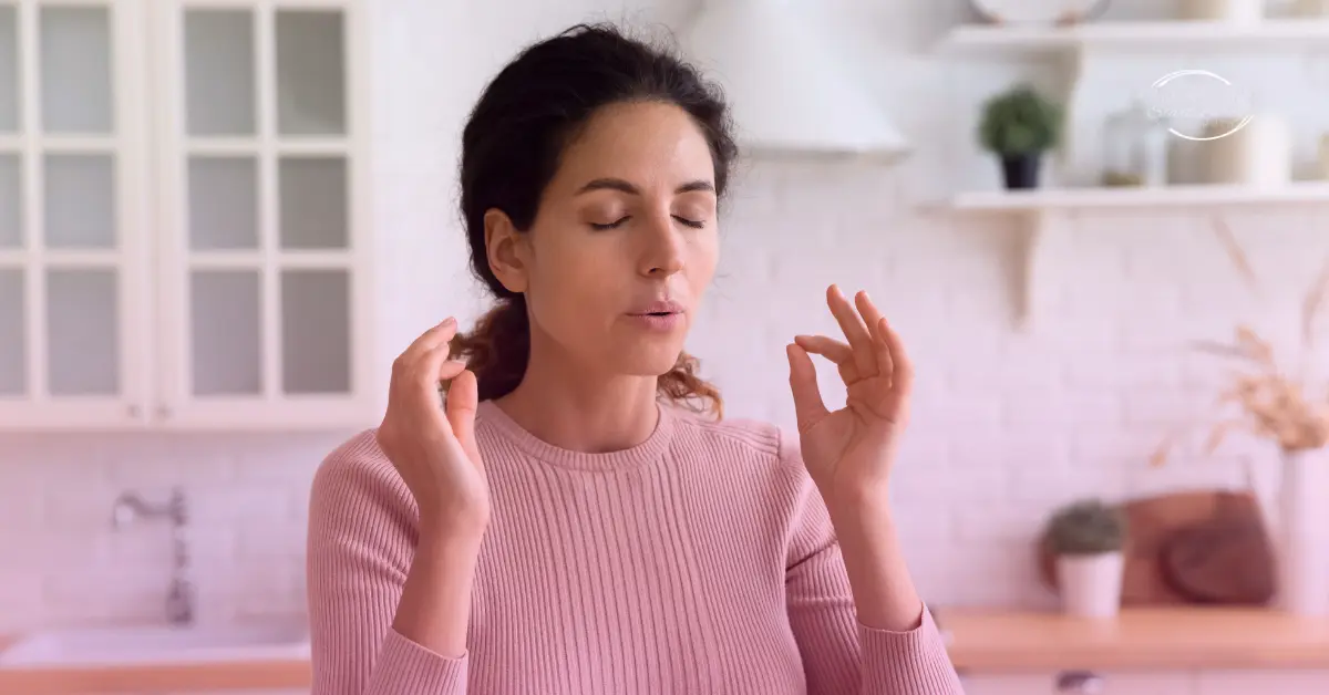 Woman practising mindful breathing in kitchen