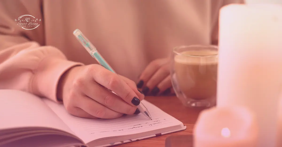 Person writing in journal with coffee nearby.