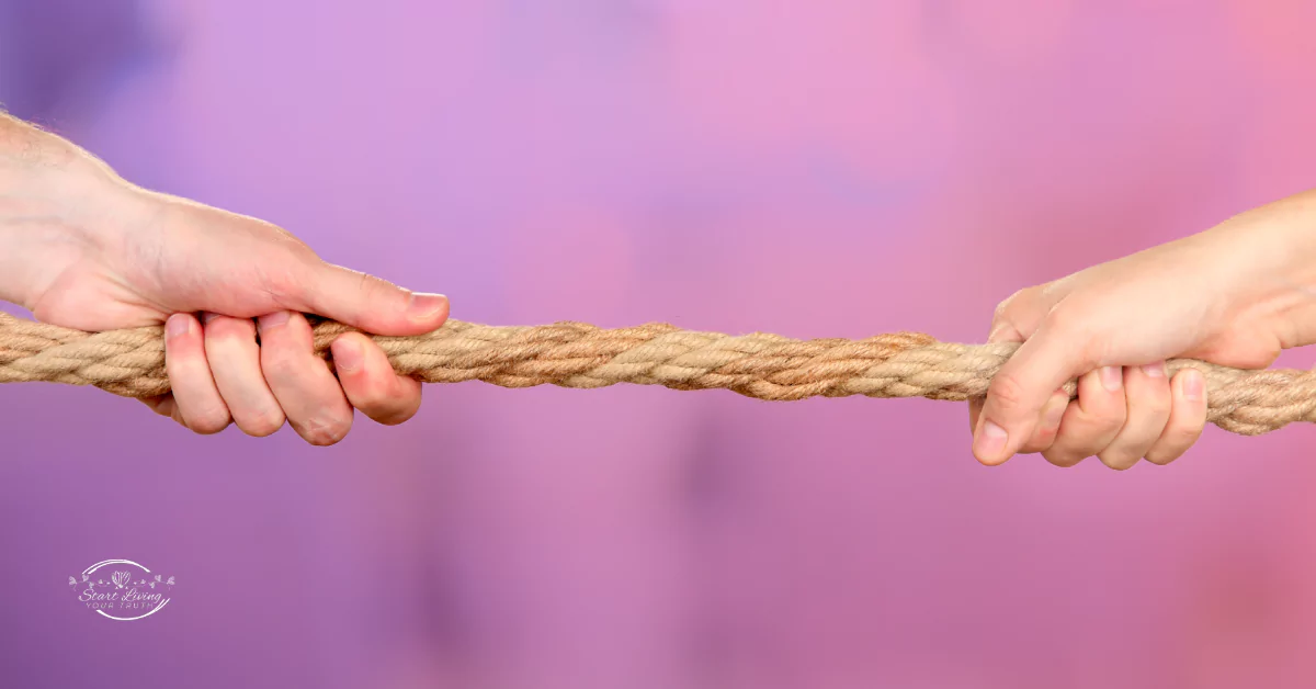 Two hands tug-of-war with rope, purple background.