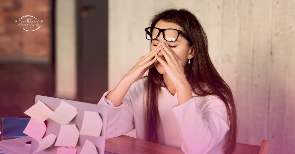 Stressed woman at desk with sticky notes.