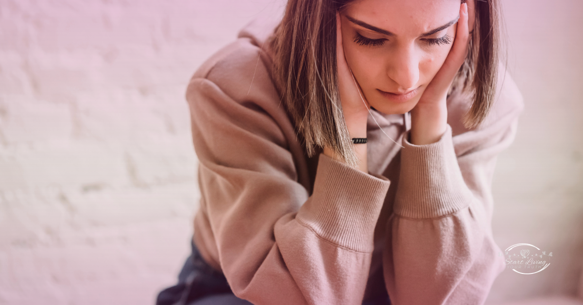 Young woman feeling stressed and worried indoors.