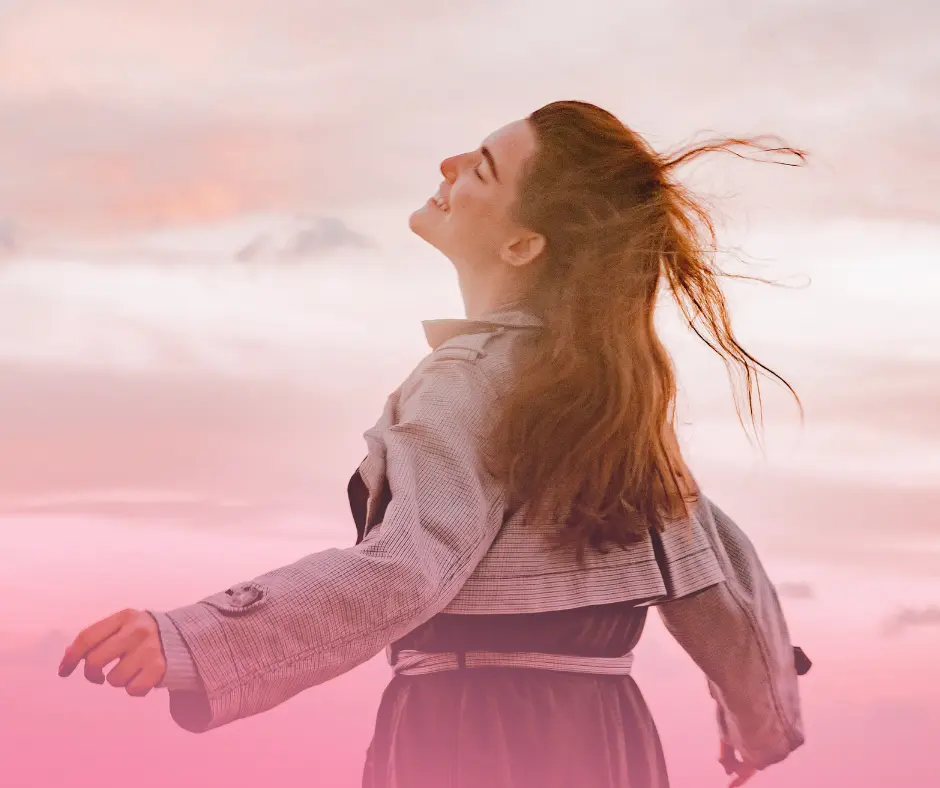 Woman enjoying the outdoors with pink sunset