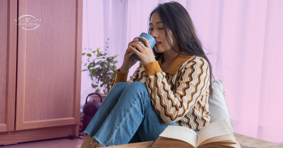 Woman enjoying coffee and reading a book.